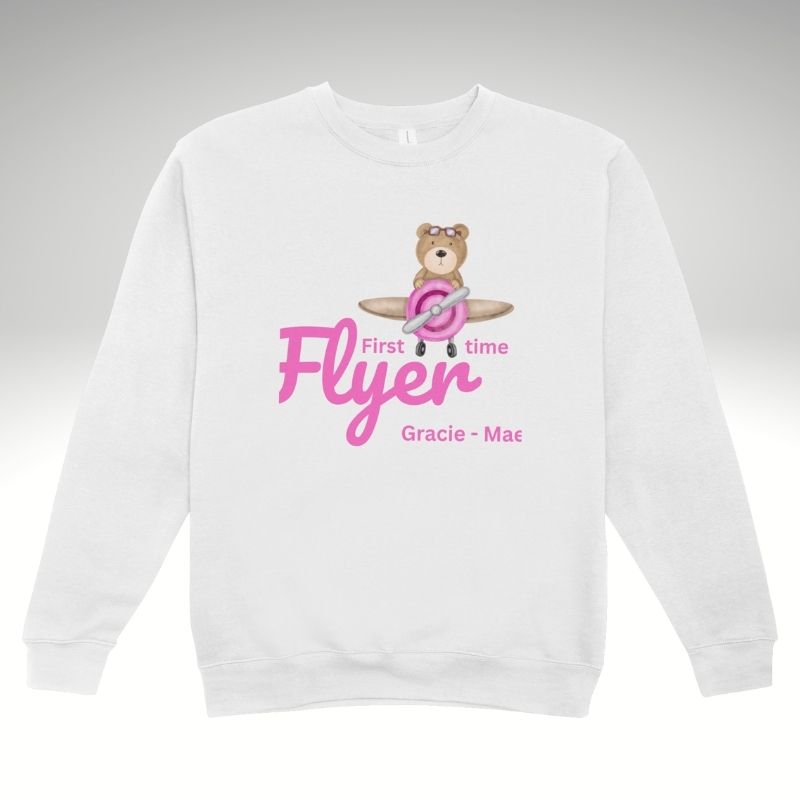 White sweatshirt with a bear graphic 'First time Flyer' and text on a gray background