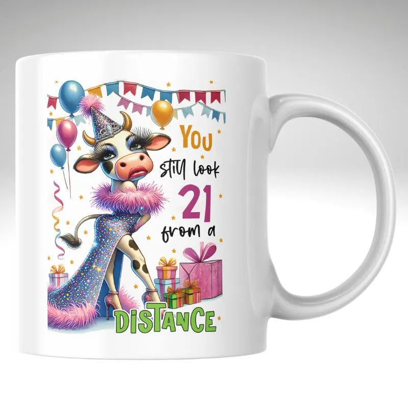 Mug with a cow illustration and birthday-themed text on a white background
