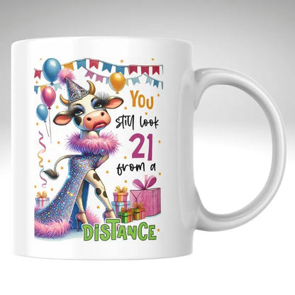 Mug with a cow illustration and birthday-themed text on a white background